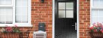 black composite doors Woking installed into brick home