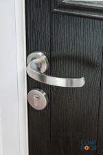 A composite door handle on a black composite door.